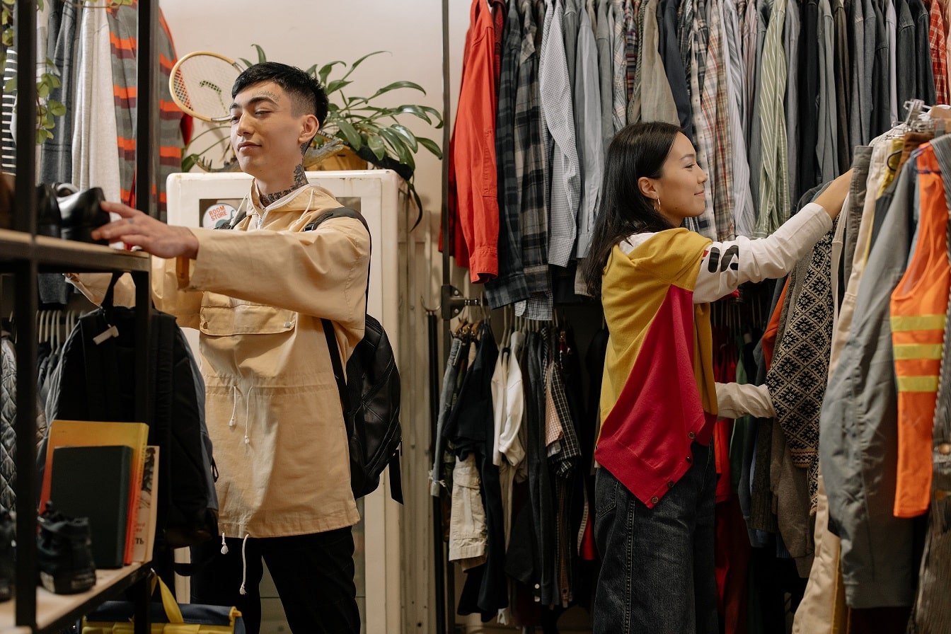 People browsing clothes on the hangers